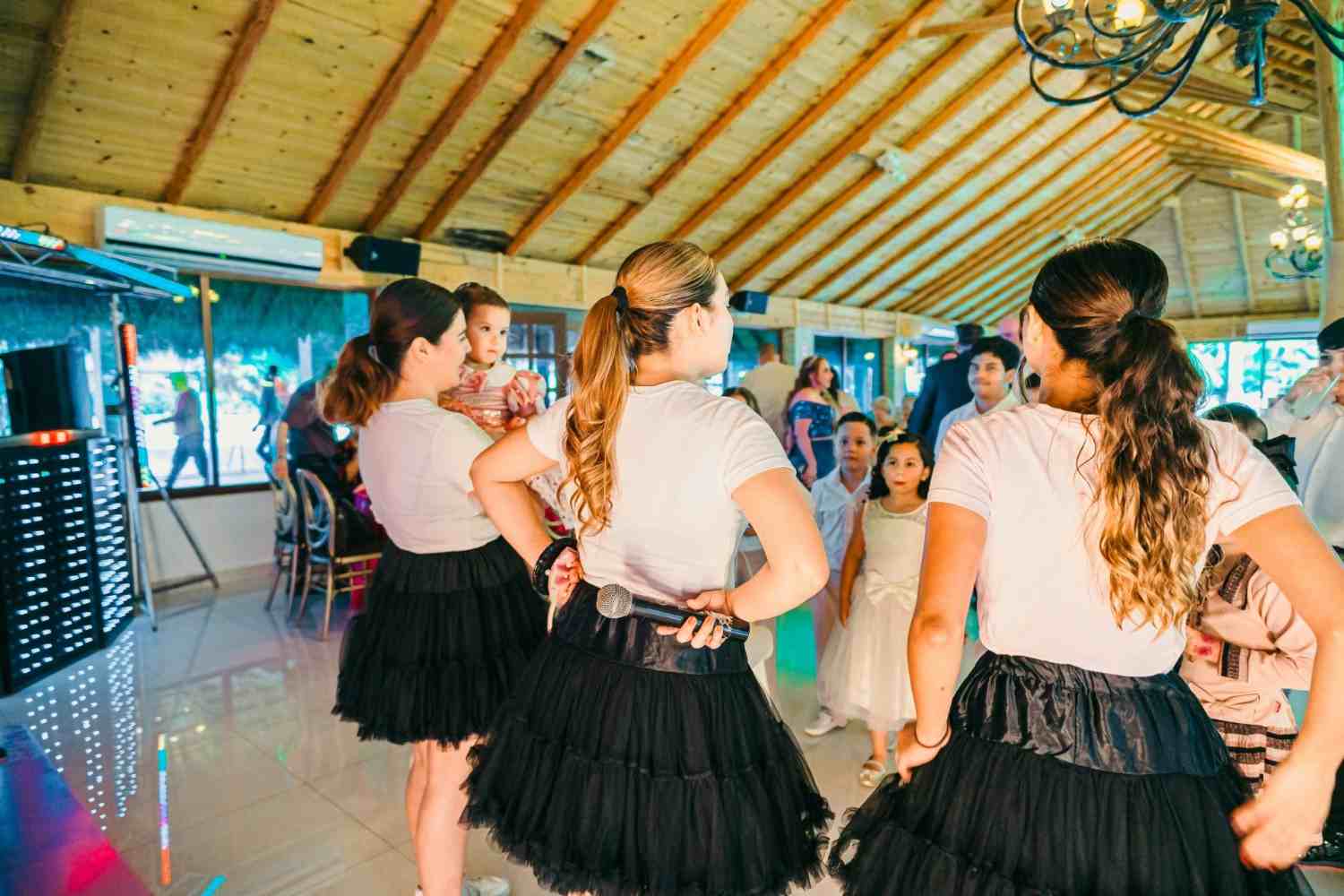 Young women in skirts dancing at a party